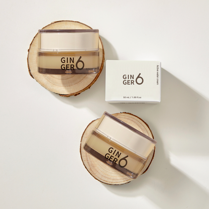 Top-down view of Ginger6 Active Water Day Cream jars and packaging box resting on natural wood slices